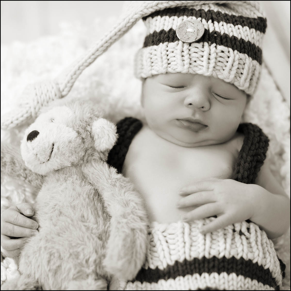 Baby sleeping holding a cuddly toy