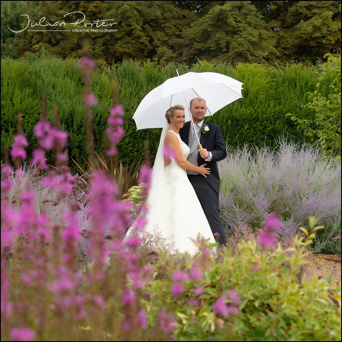 Bride and groom under a umbrella