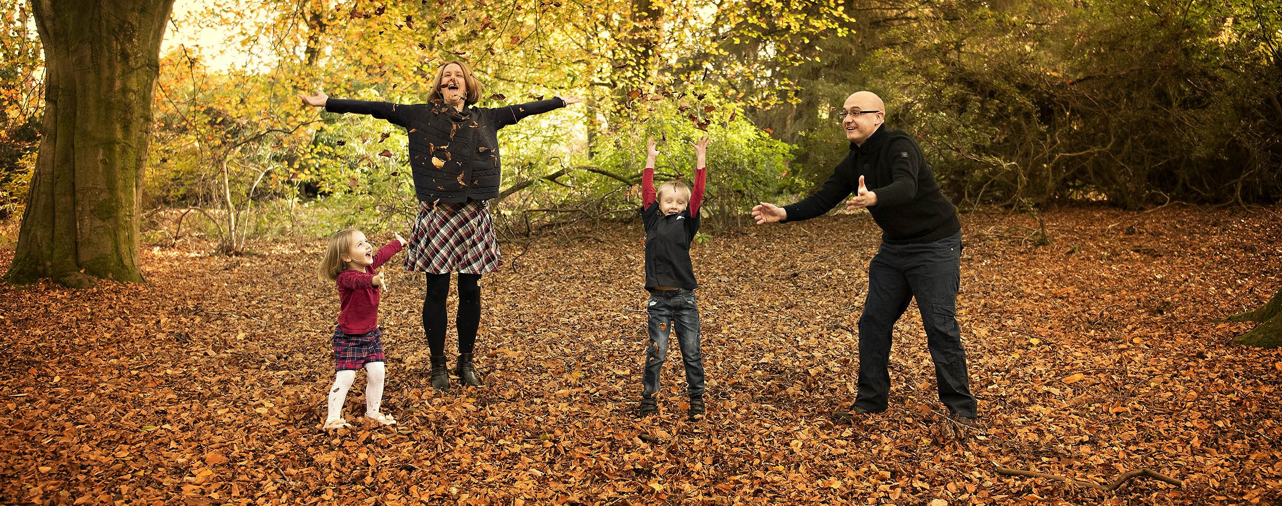 Family playing with leaves